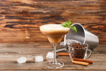 Glass of coffee martini on wooden background