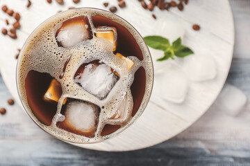 Glass of coffee martini on wooden background
