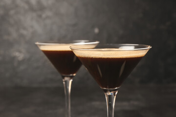 Glasses of coffee martini on dark background
