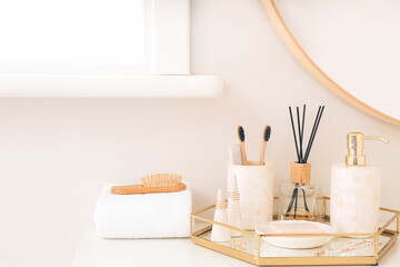 Soap with toothbrushes on table in bathroom