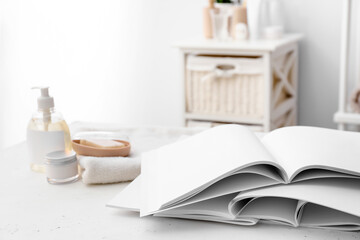 Open blank magazines on table in bathroom