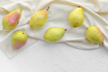 Composition with fresh pears on light background