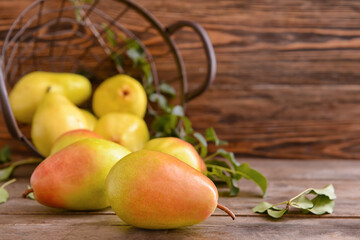 Composition with fresh pears on wooden background