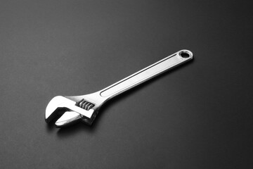 Metal wrench on dark background