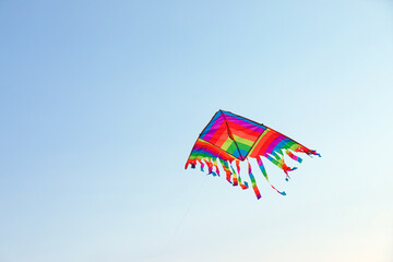 Colorful kite flying in blue sky