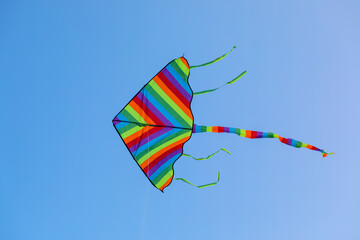 Colorful kite flying in blue sky