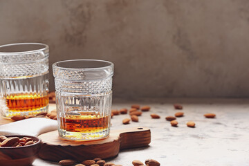 Glasses of almond liquor and nuts on table