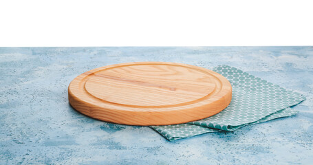 Wooden cutting board on color table against white background