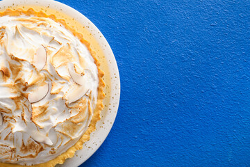 Plate with tasty coconut pie on color background