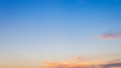 Beautiful sky painted by the sun leaving bright golden shades.Dense clouds in twilight sky in winter evening.Image of cloud sky on evening time.Evening sky scene with golden light from the setting sun