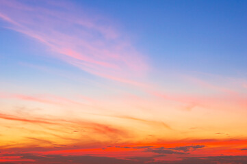 Beautiful sky painted by the sun leaving bright golden shades.Dense clouds in twilight sky in winter evening.Image of cloud sky on evening time.Evening sky scene with golden light from the setting sun