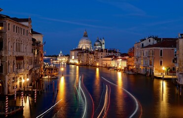 Boat lights trecks on water.  Grand canal from Academia bridge in Venice at twilight. Italy. 