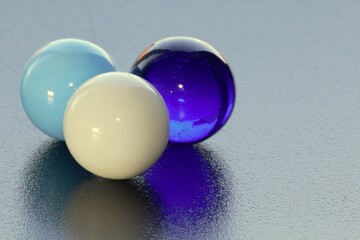 3 lovely coloured marbles on black surface - stock photo