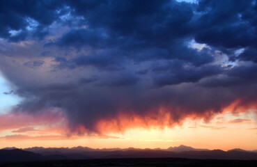 Fototapeta na wymiar dramatic sunset over long's peak and the front range of the colorado rocky mountains as seen from broomfield, colorado