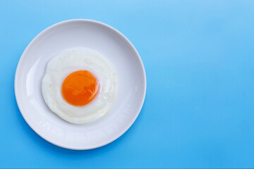 Fried egg on blue background.