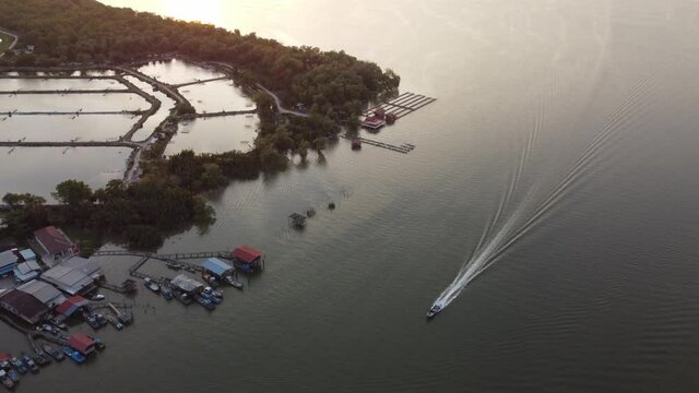 Fishing boat sail back village Sungai Udang in evening sunsey hour