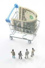 miniature people. businessmen stand near a grocery basket with dollars. consumer goods business