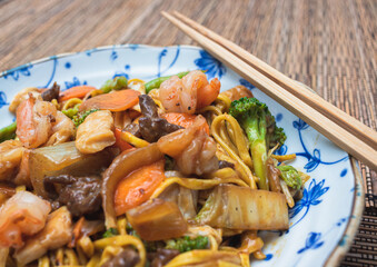 Oriental food yakissoba in wood floor.