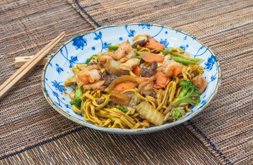 Oriental food yakissoba in wood floor.