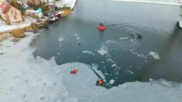 Polish Lifeguards Exercise Ice Rescue Training At Frozen Lake In Mikolajki, Poland. - aerial