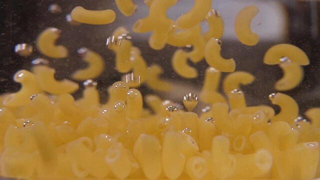 macaroni pasta in pot with boiling water 4k