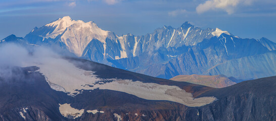 Mountain landscape, panoramic view. Snow-capped peaks, glaciers. Mountain climbing and mountaineering.