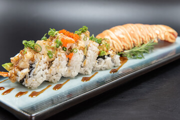 Lobster sushi roll with beautiful presentation on the plate including the shell.