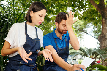 Coffee owner making face palm gesture when his and his coworker finding serious mistake in accounting documents