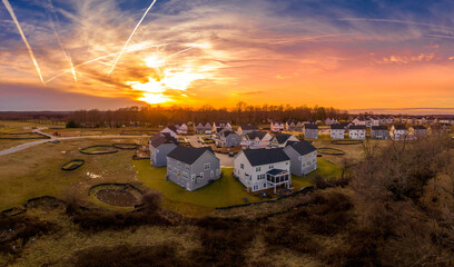 Suburban neighborhood street with newly constructed single family homes in an American  residential...