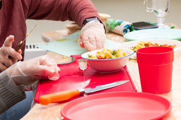 children in a school class at a labor lesson prepare a vegetable salad. parts of hands close-up. selective focus
