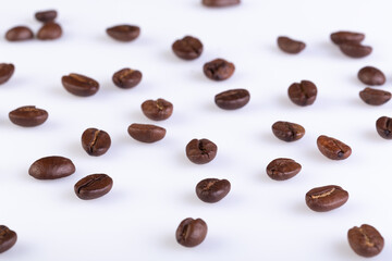 Arabica Coffee Beans Arranged on a white background, selective focus.