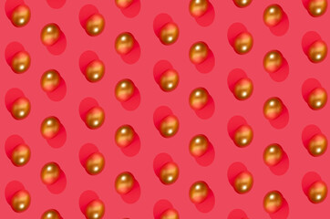 Golden eggs on pink background. Minimalist pattern concept. Flat lay