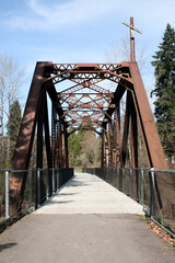 An old railroad bridge now accommodates a paved walking, biking, skating path.