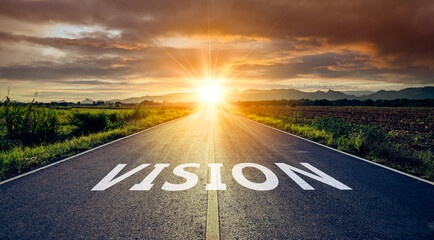 New year or start straight concept.word vision written on the road in the middle of asphalt road at sunset.Concept of planning and challenge or career path,business strategy,opportunity and change © Yingyaipumi
