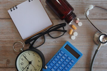 pills and note book on wooden background