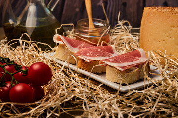 local products Still life of Serrano ham with tomatoes and olive oil