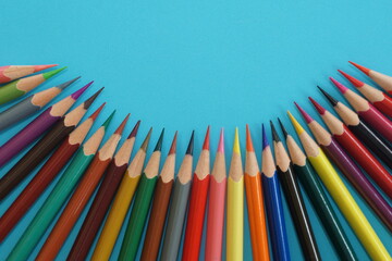 Fototapeta premium colored pencils on blue background