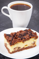 Fresh baked cheesecake on white plate and black coffee. Delicious dessert for different occasion