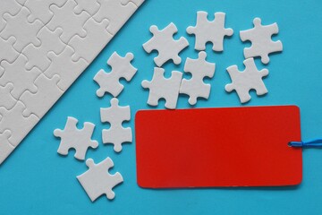 white jigsaw puzzle with red tag
