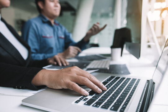 Two asian team working development of programming and encryption technology website design programmers on desk in office.