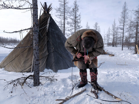 Ethnography. A ski hunter sets a trap for a wild animal. Indigenous peoples of the Arctic. Art noise