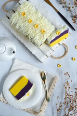 top view of cake topped with grated cheese and flower gum paste