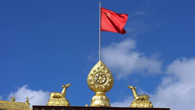 Dharma wheel and Chinese flag at Songzanlin monastery in Shangri-La Yunnan China
