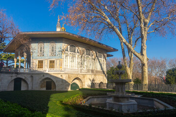 Fountain in garden near Baghdad Pavilion in Fourth Court of Topkapi palace on sunny winter day, Istanbul, Turkey.