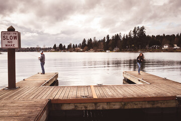 father and daughter fishing on dock 