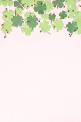 Saint Patrick's Day concept. Border of decorative paper clover leaves on white background.