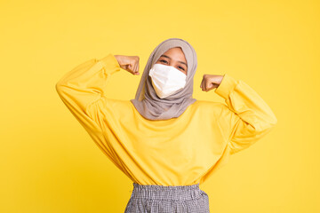 Woman wearing face mask during coronavirus outbreak isolated on yellow background.