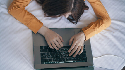 female hands typing text on laptop keyboard close-up