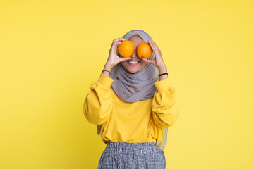 woman with orange on yellow background.