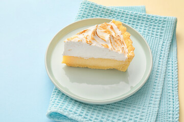 Plate with piece of tasty coconut pie on color background